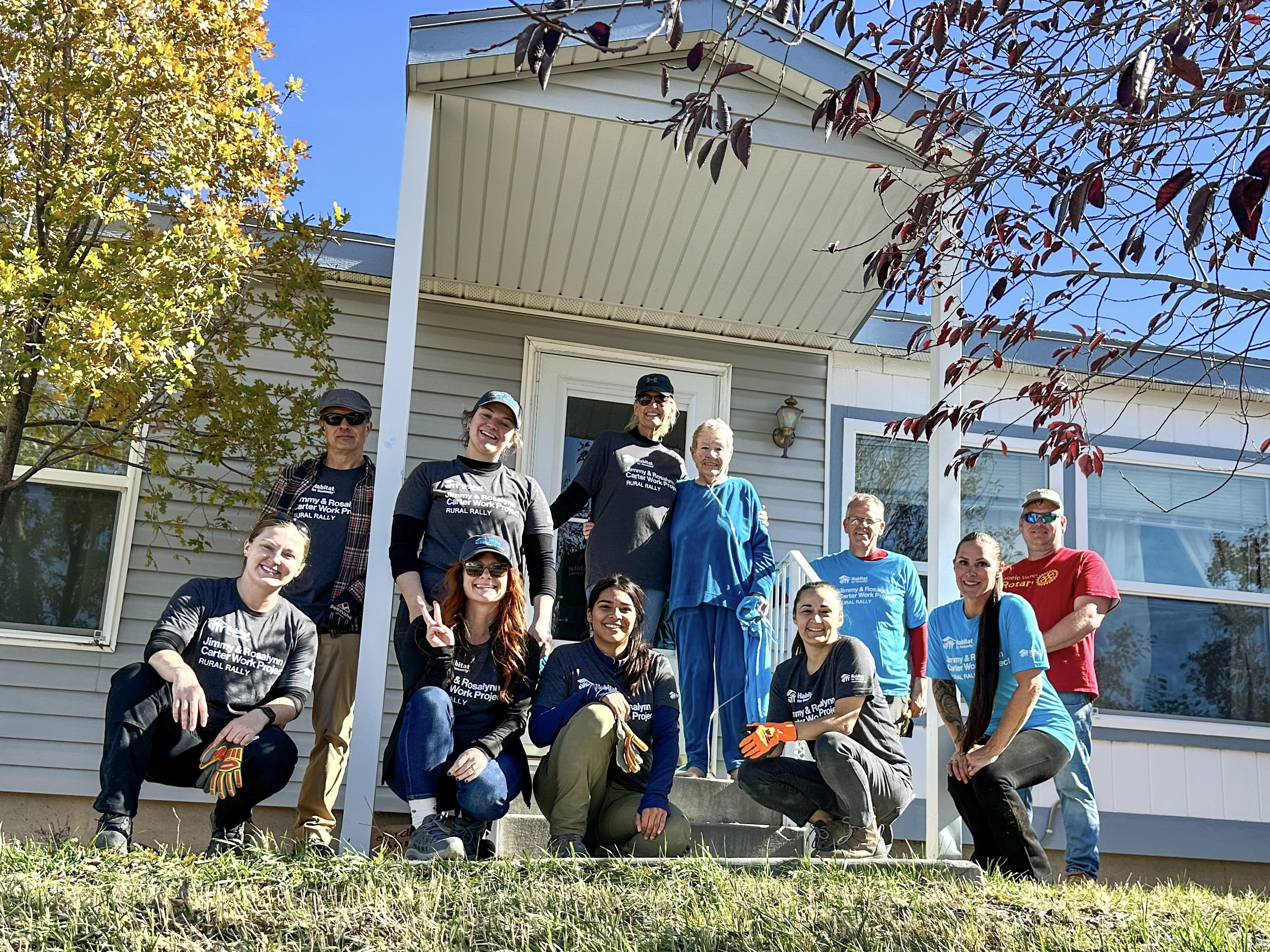 Habitat volunteers and homeowners working together on an exterior project
